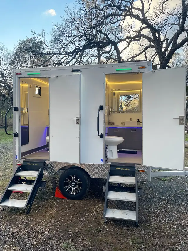 Restroom trailer with its stall doors open